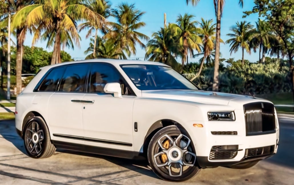 White Rolls-Royce Cullinan beneath Miami palm trees